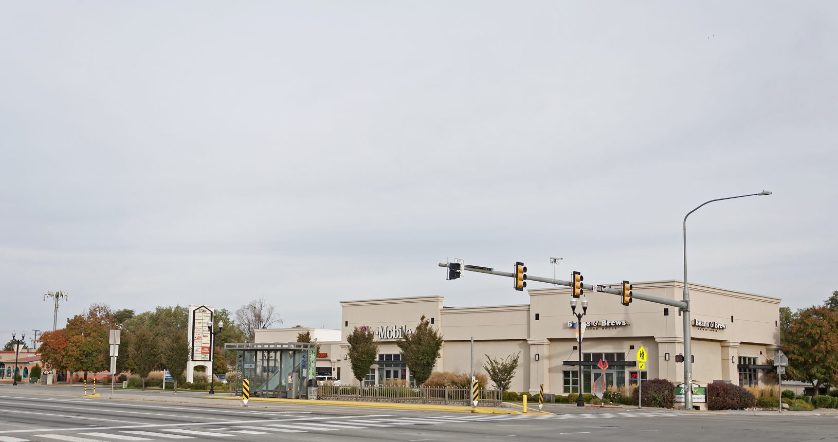 A street light and some buildings on the side of a road.