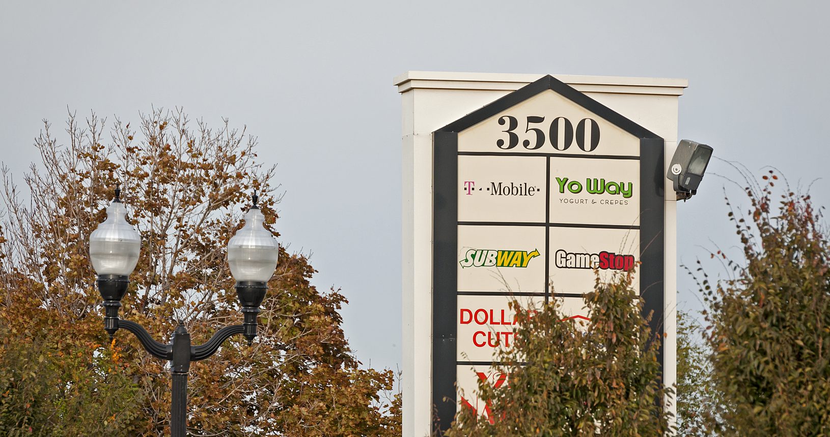 A tall sign with several different types of signs on it.