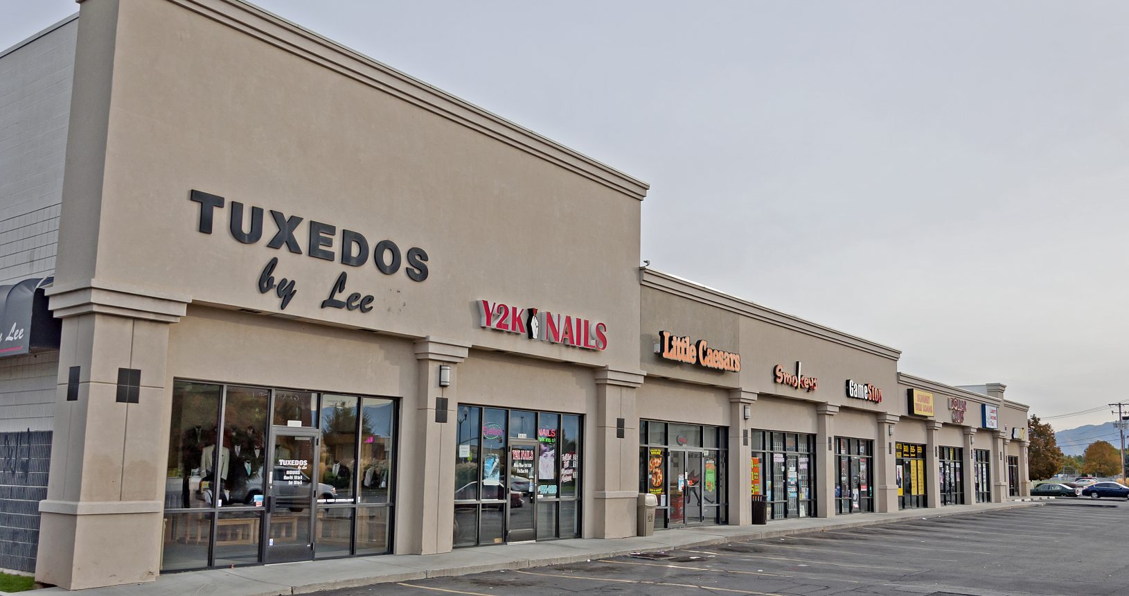 A row of stores on the side of a street.