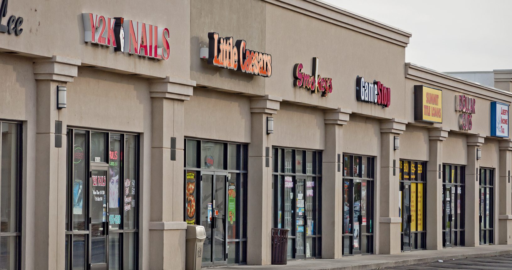 A row of stores on the side of a street.