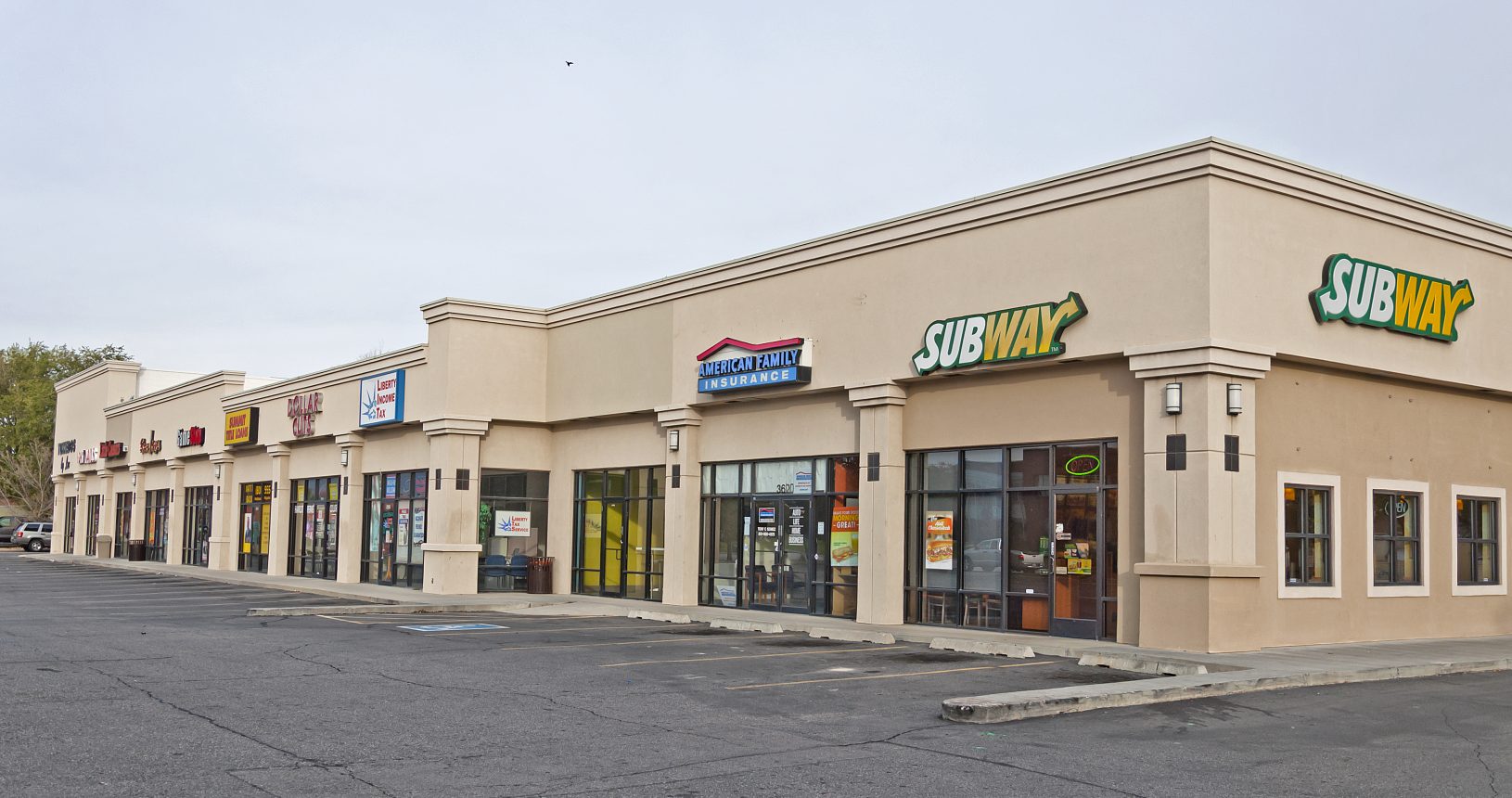 A large store front with many different signs on it.