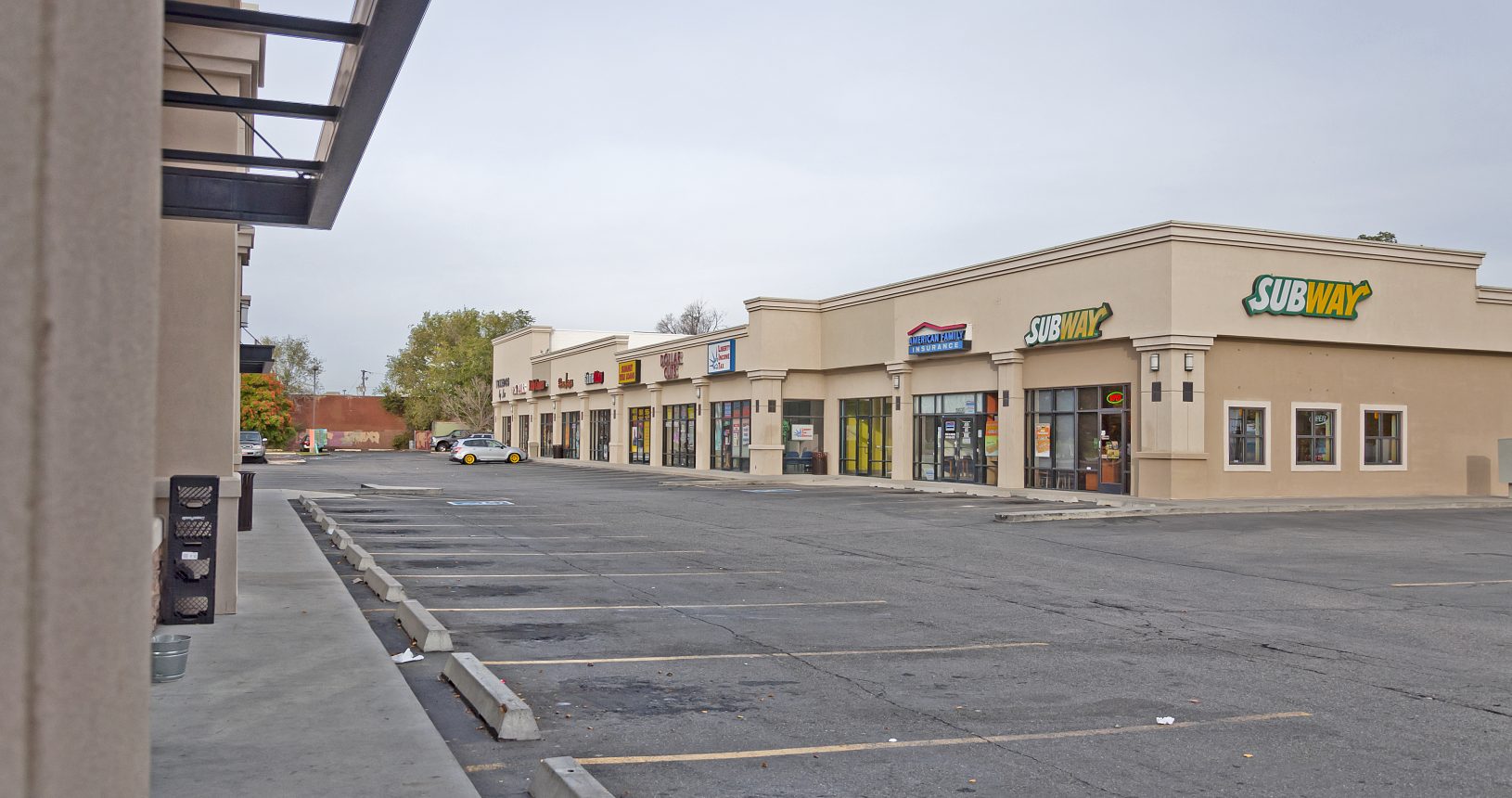 A deserted street with many stores on the side.