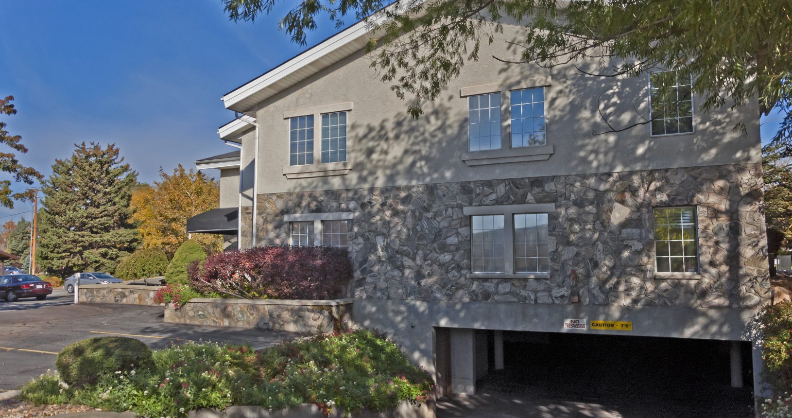 A large stone building with garage in front of it.