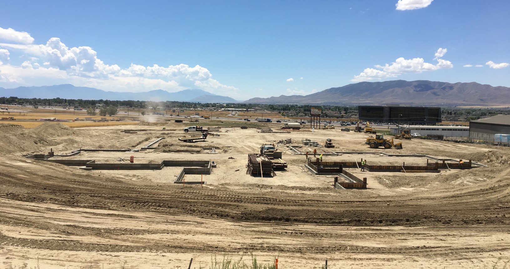 A large field with many construction equipment on it.