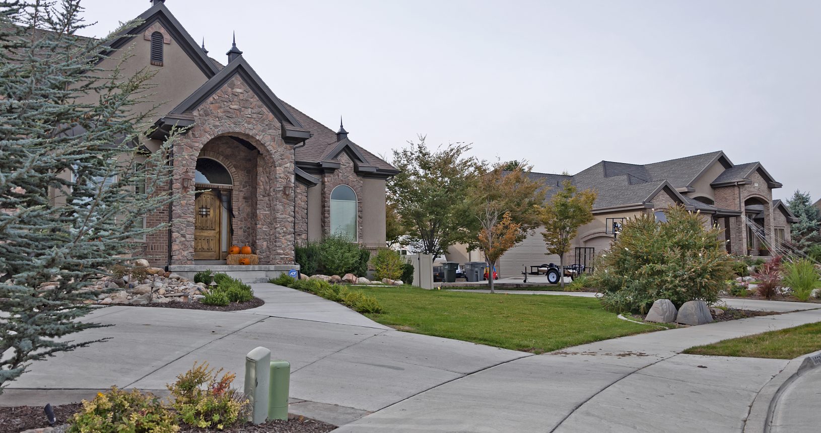 A large brick house with a lot of green grass.