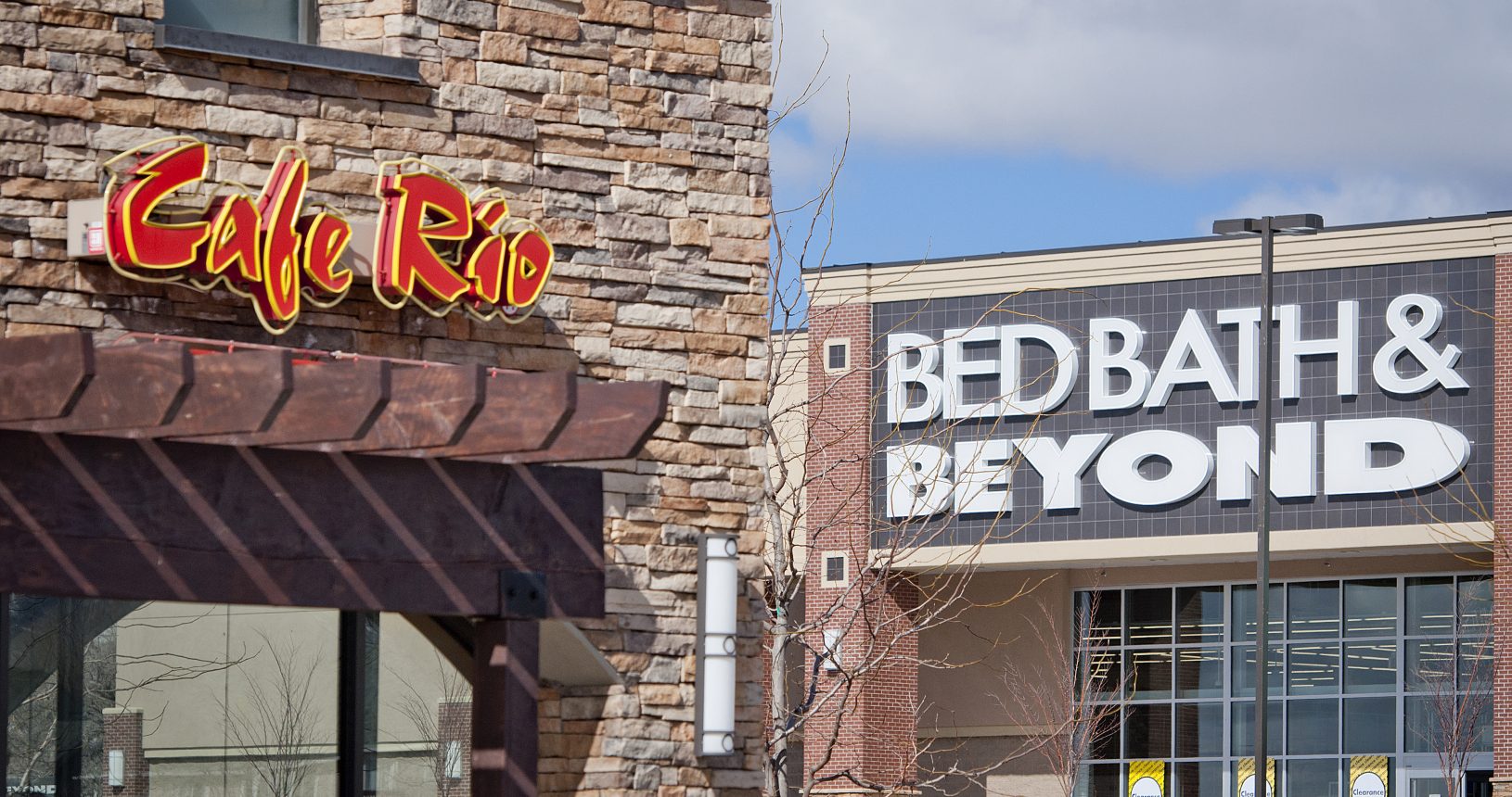 A store front with a bed bath and beyond sign in the background.