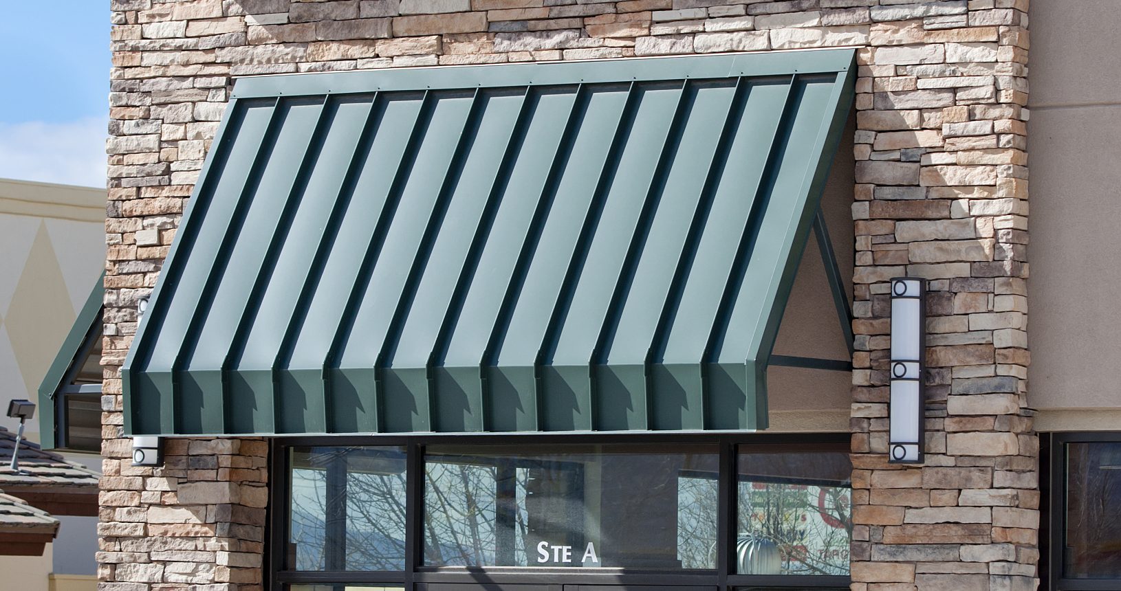 A red mango store front with an awning over the entrance.