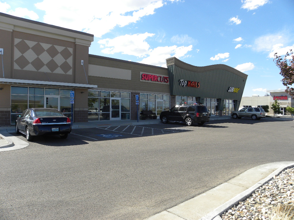 A car parked in front of a store.