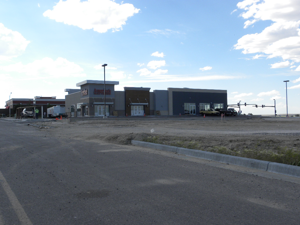 A large empty lot with many buildings in the background.