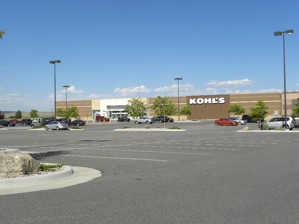 A large parking lot with cars parked in it.