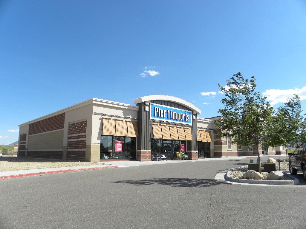 A large building with a store front on the side.