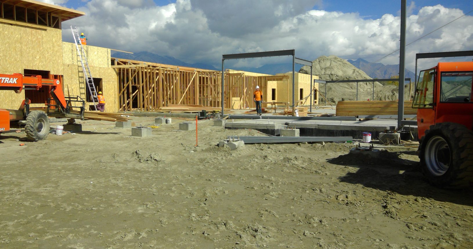 A construction site with many wooden frames and concrete.