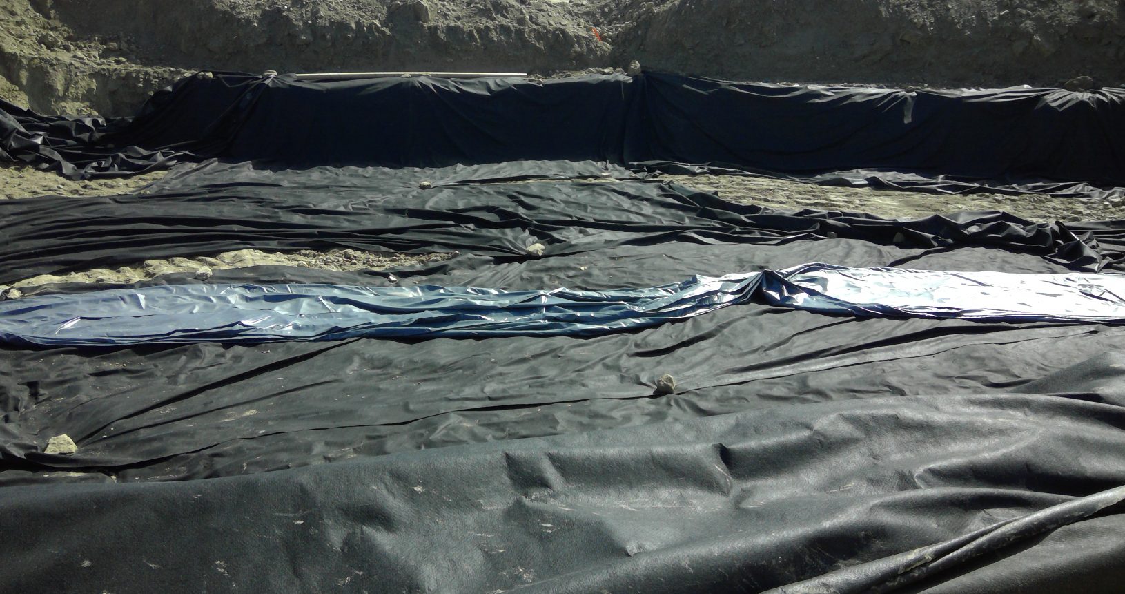 A large black tarp covering the ground.