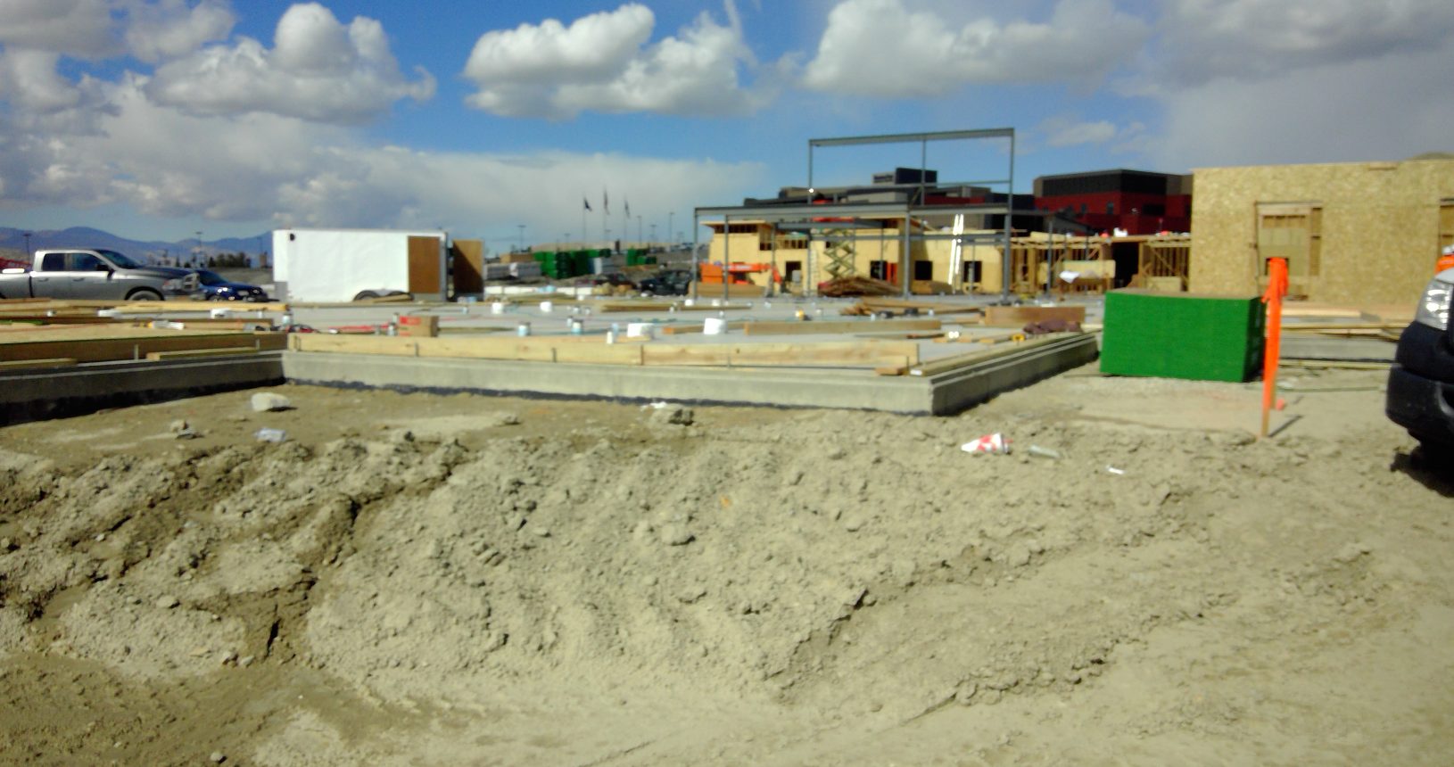 A dirt field with some buildings in the background