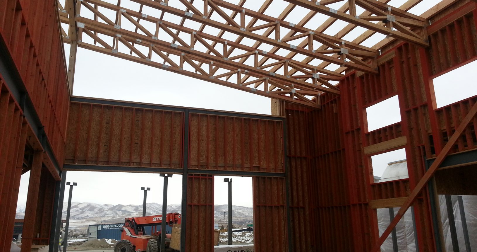 A construction site with a tractor and building