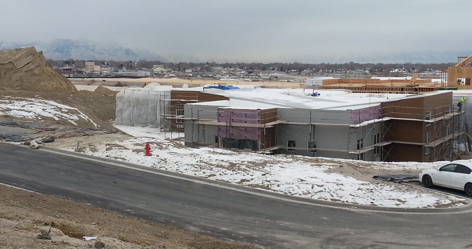 A building that is under construction in the snow.