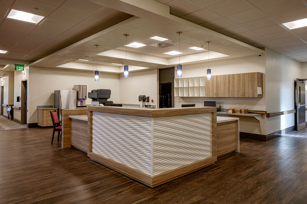 A large room with a wooden counter and some lights