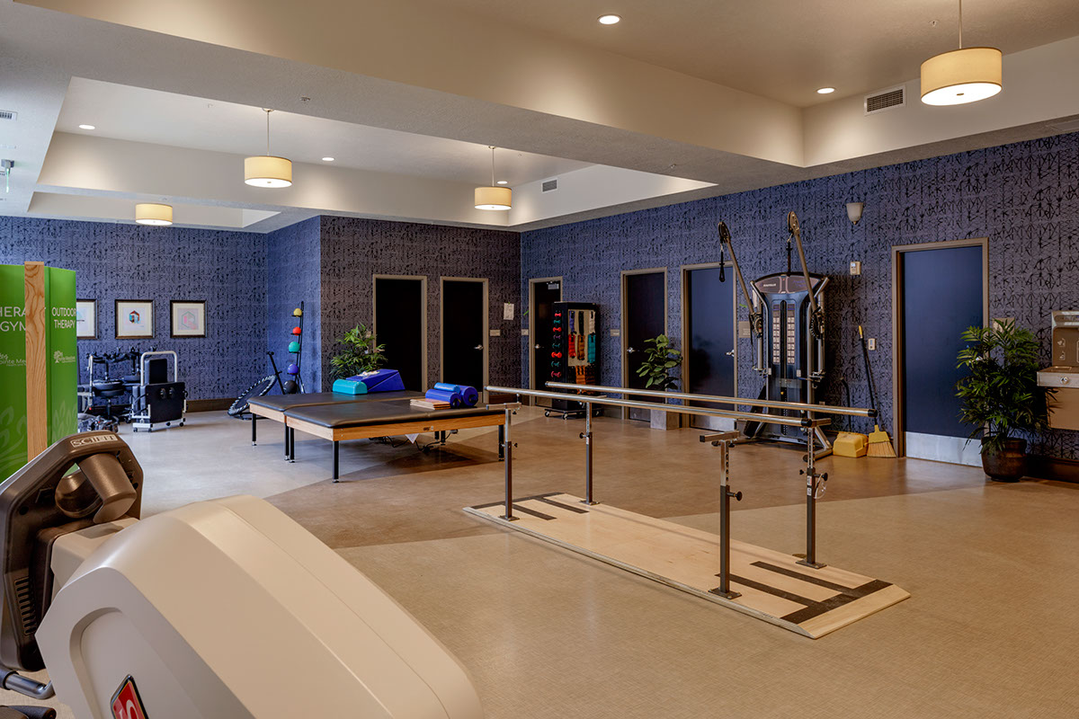 A gym with blue walls and a bench