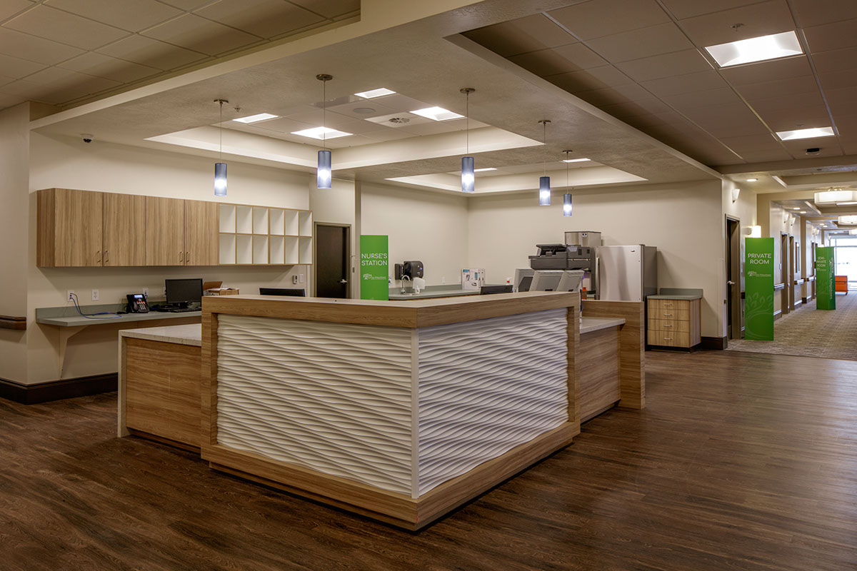 A large open kitchen with white walls and wooden floors.