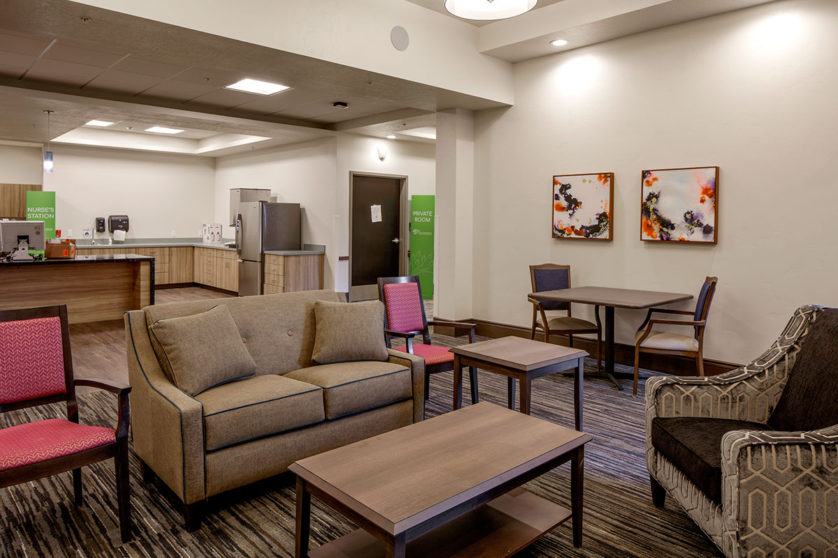 A living room with couches, tables and chairs.