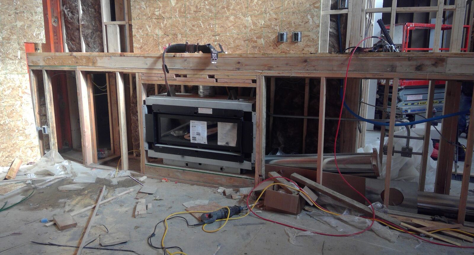 A kitchen being remodeled with an oven and cabinets.