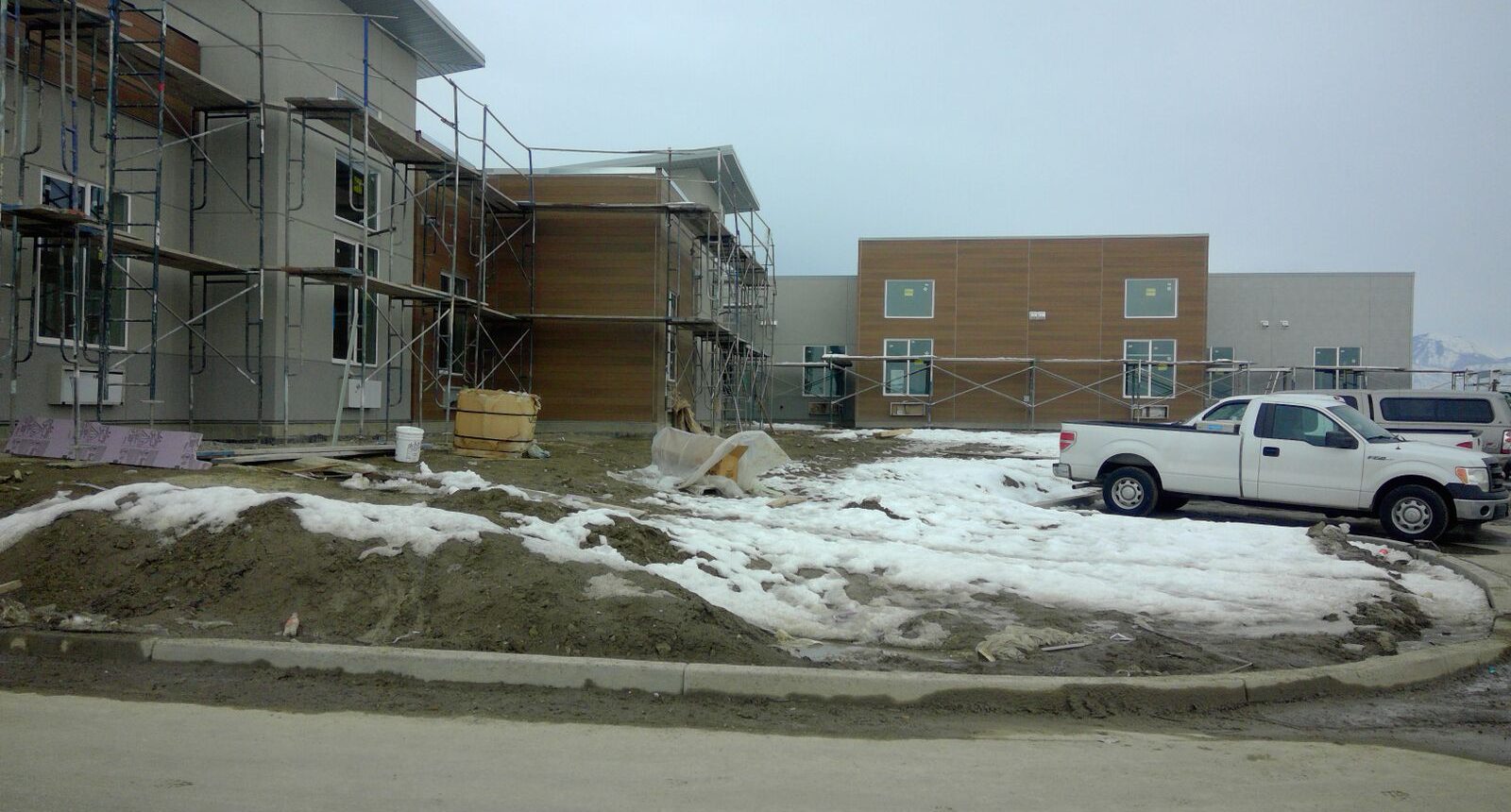 A building under construction with snow on the ground.