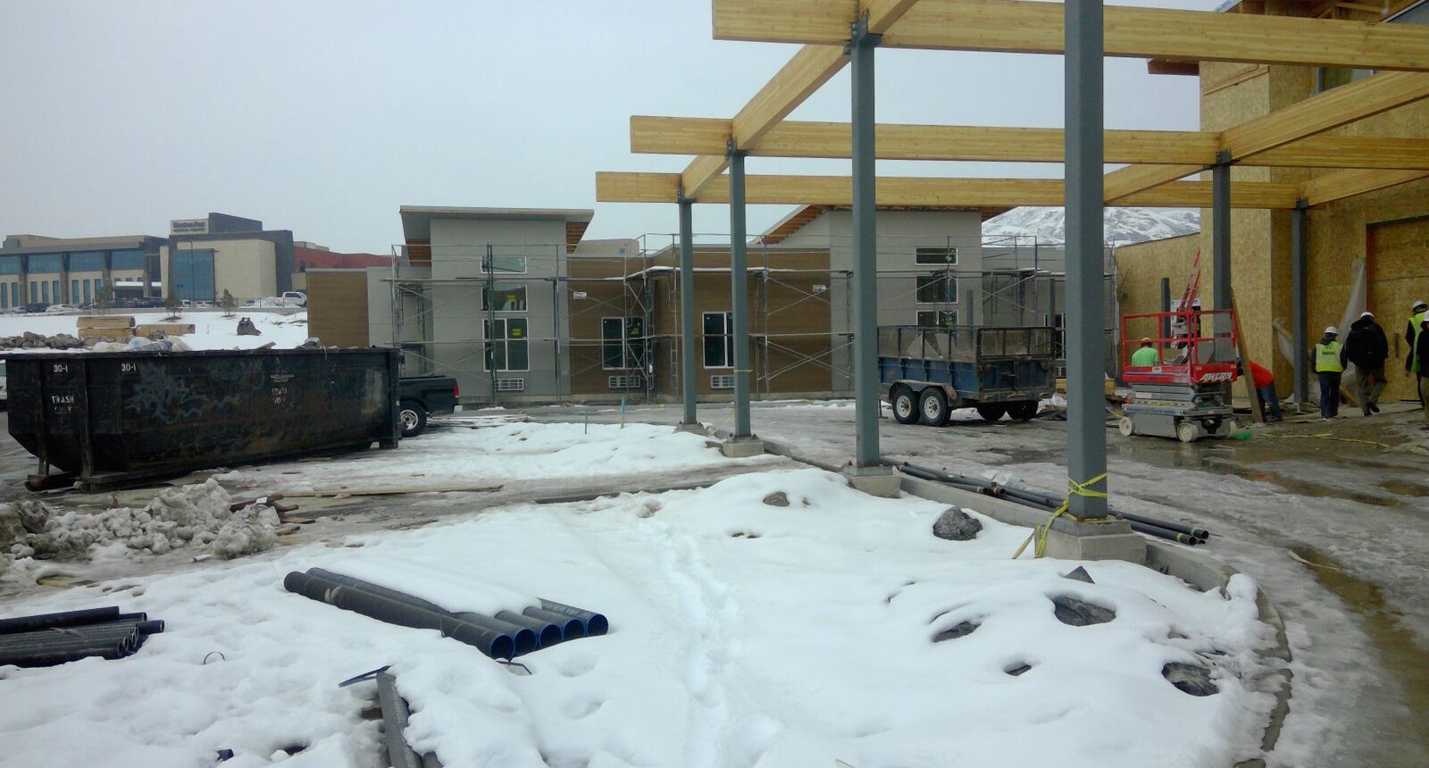 A building under construction with snow on the ground.