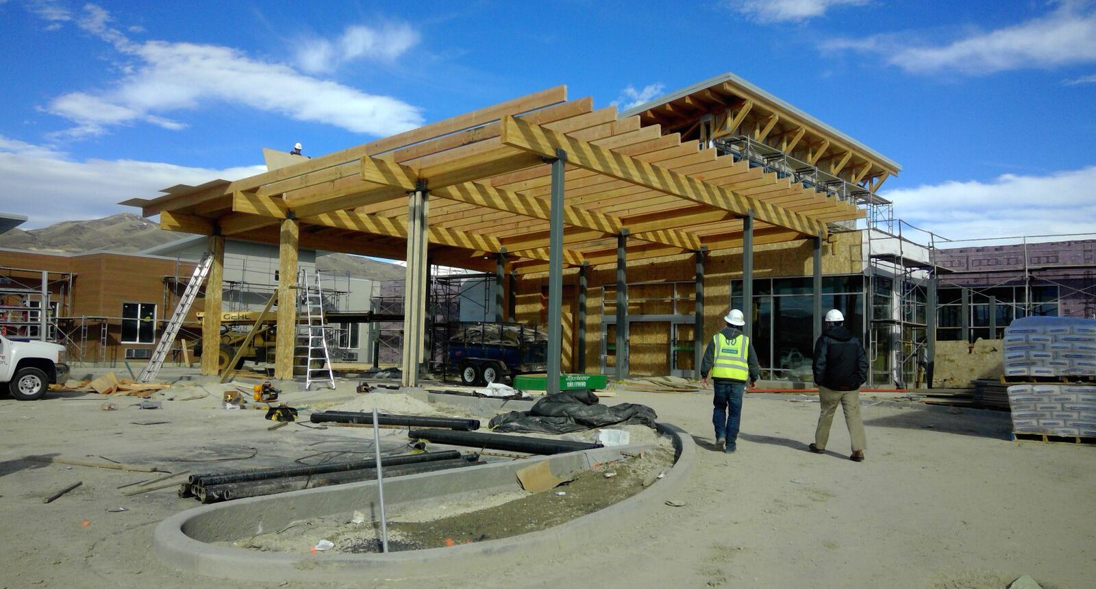 A construction site with people standing around.