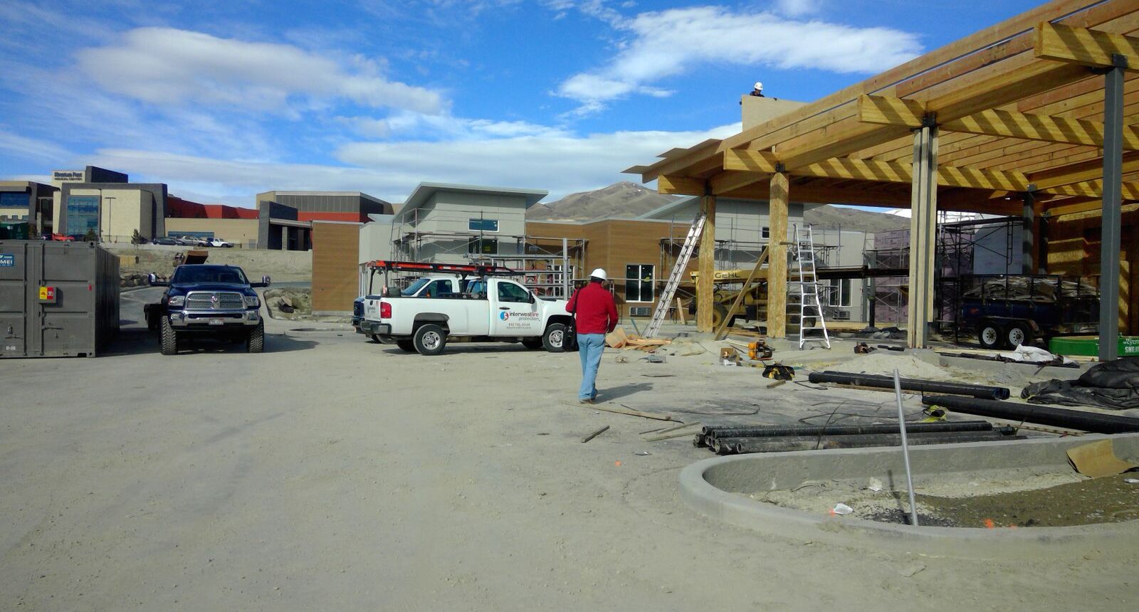 A man standing in front of a building under construction.