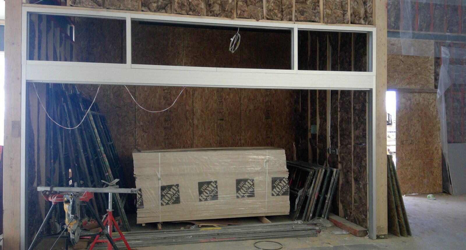 A room with a wooden bench and some wood beams