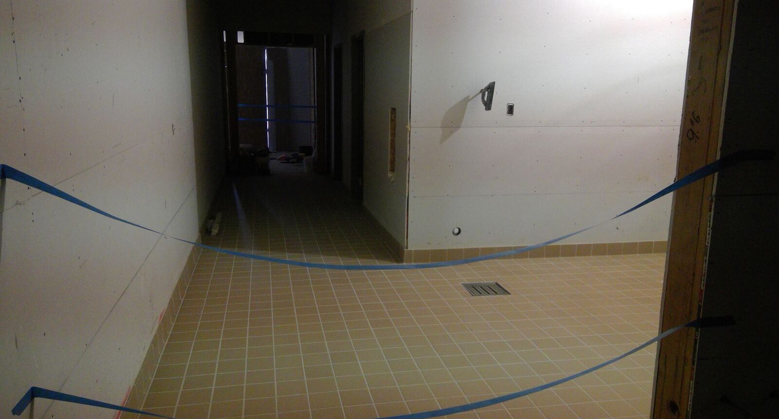 A hallway with tile floors and walls.