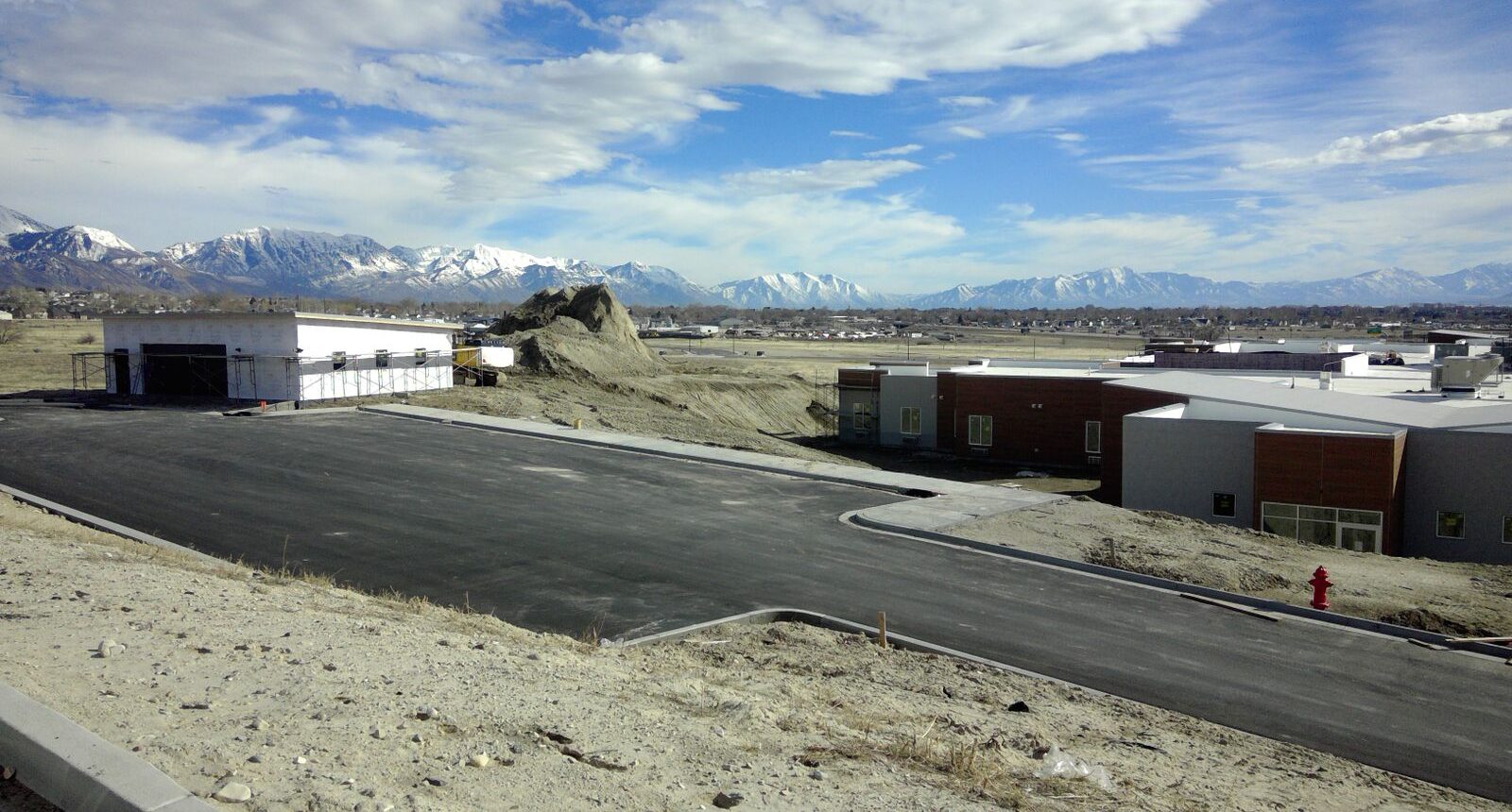 A view of an airport runway and mountains in the background.