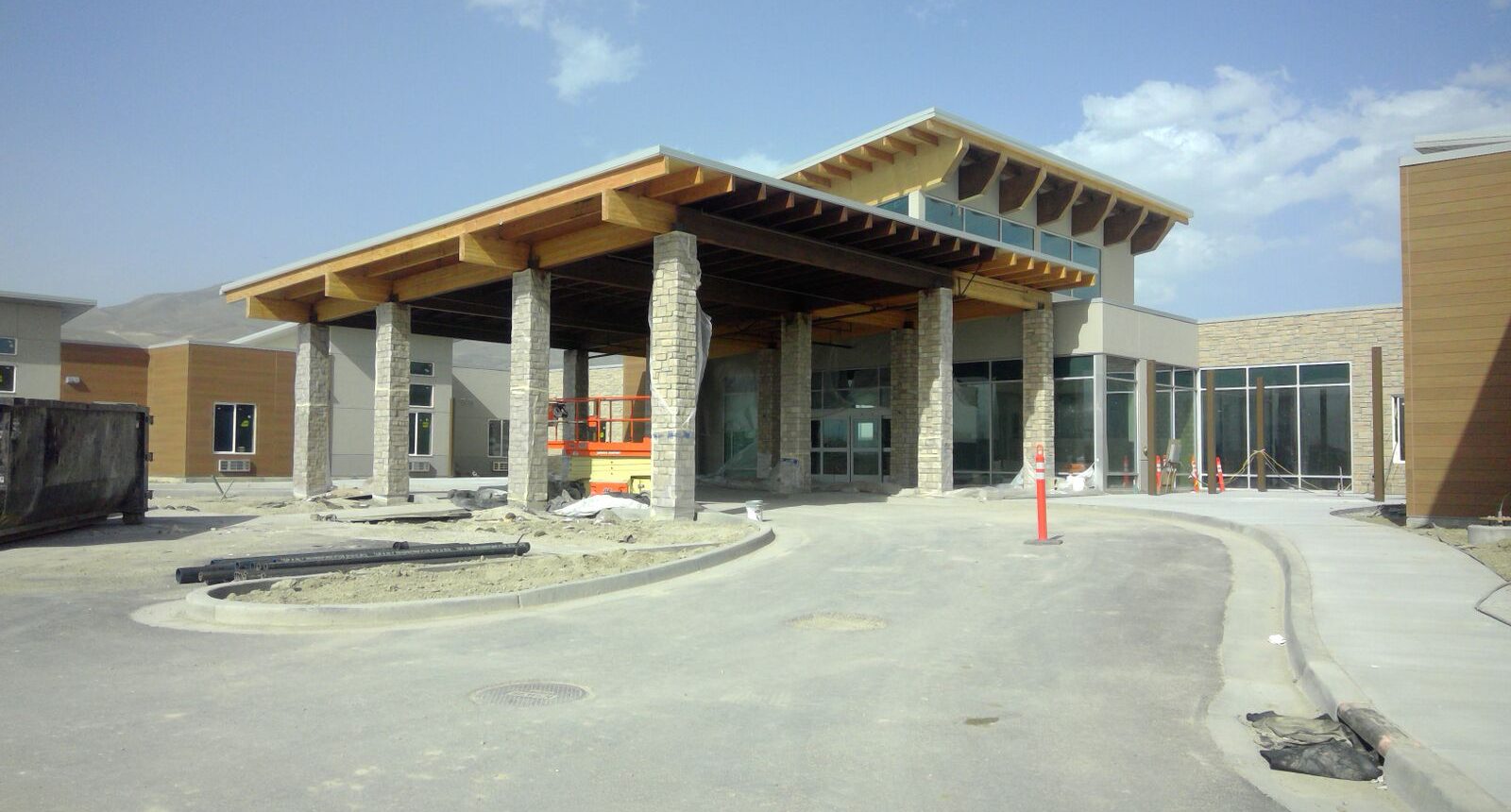 A building that is under construction with some concrete pillars.