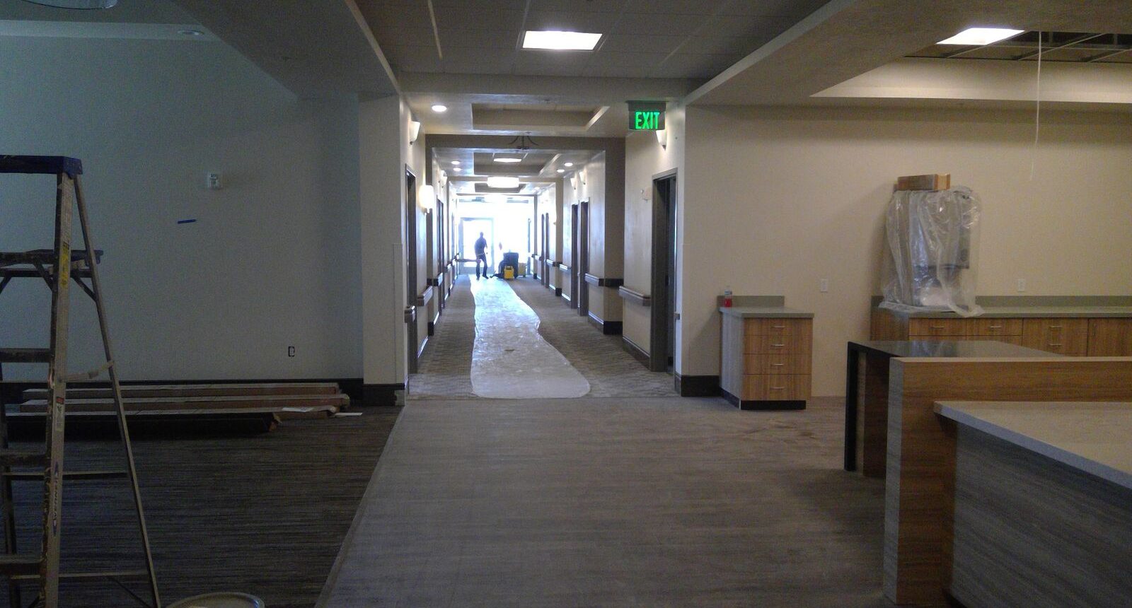 A hallway with many lights and some tables