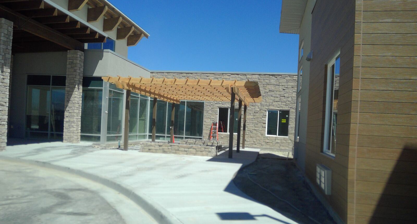 A building with a large wooden pergola over the entrance.