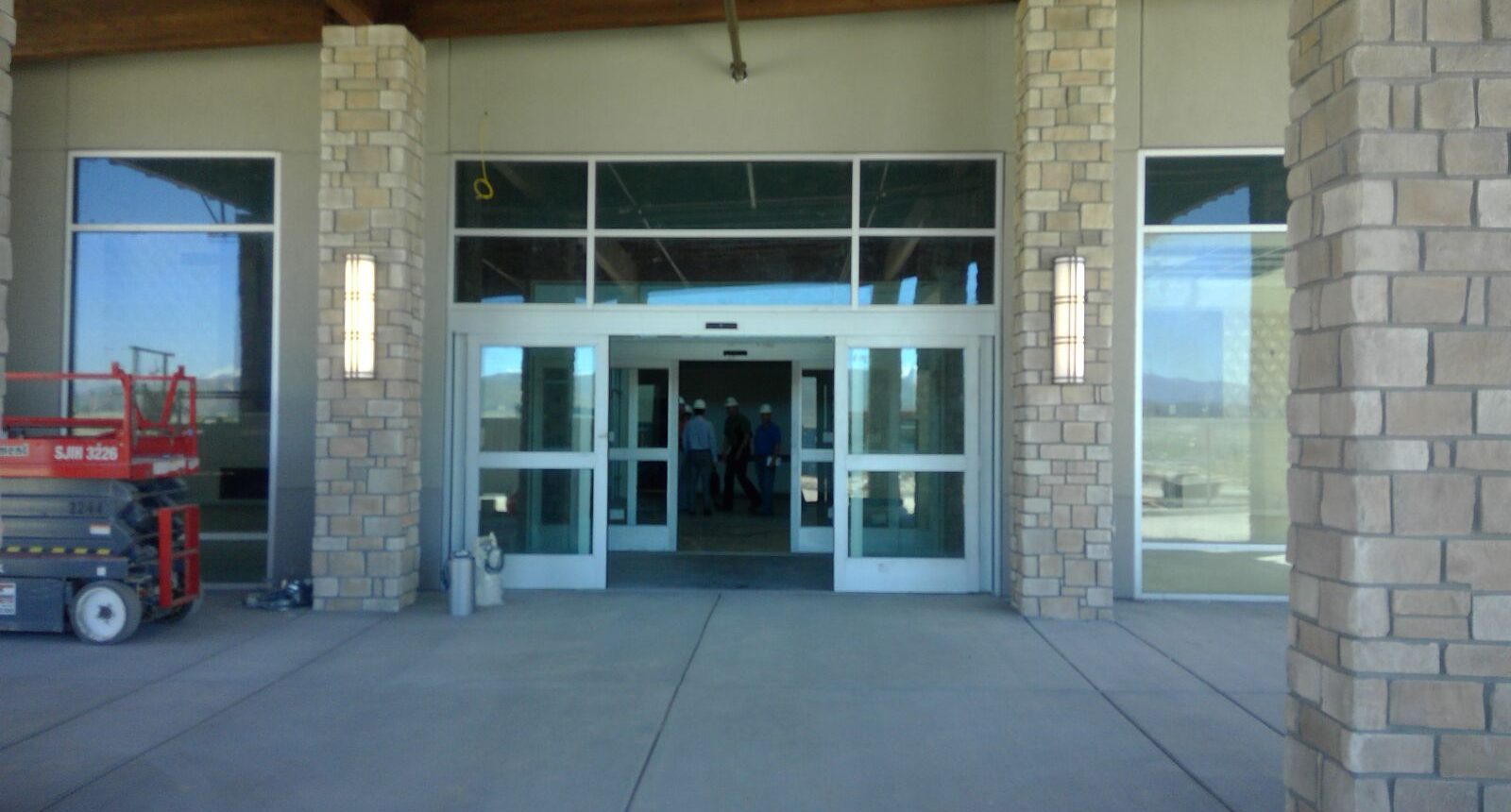 A large building with two doors and windows.