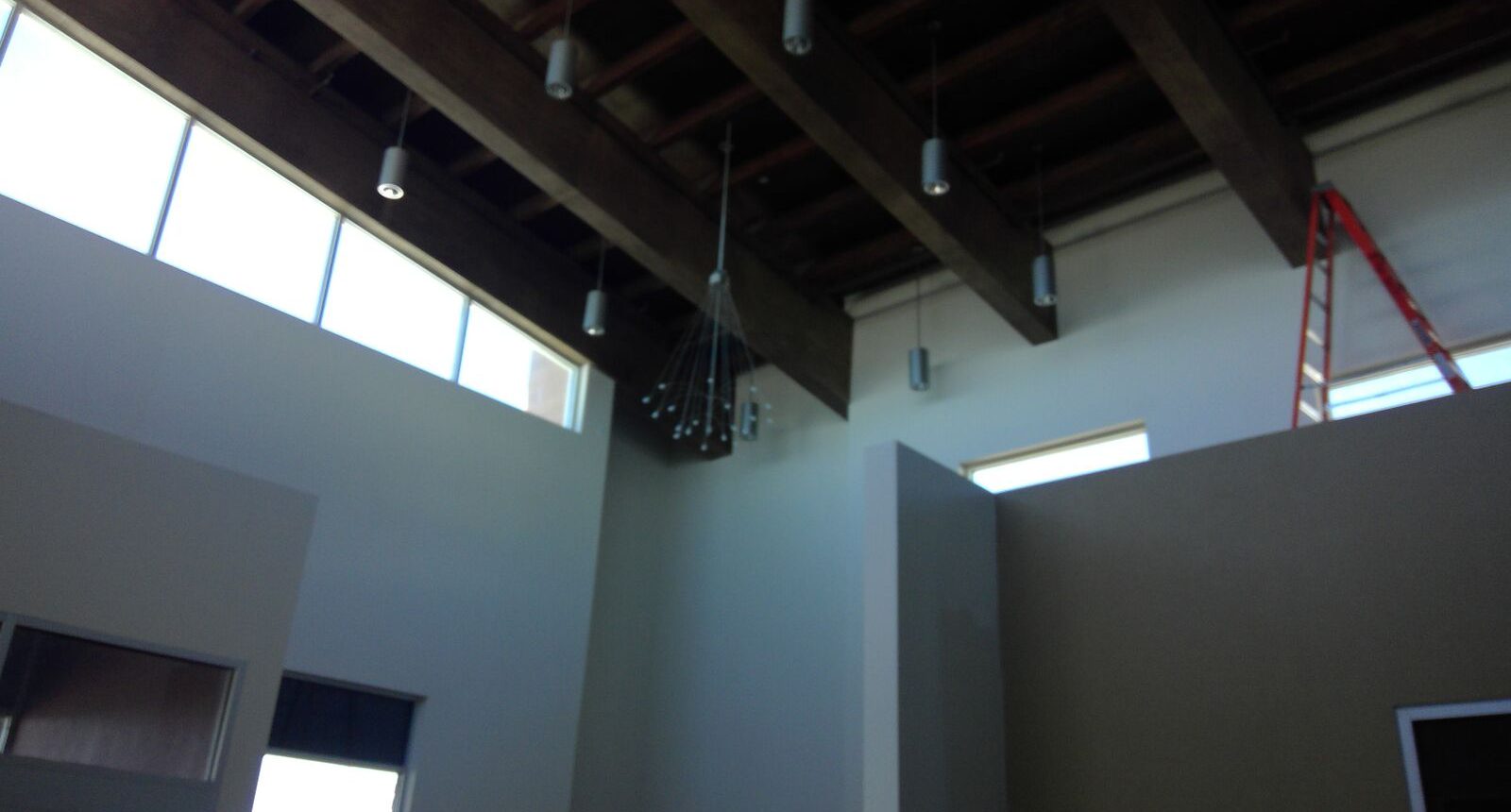 A room with several lights hanging from the ceiling.