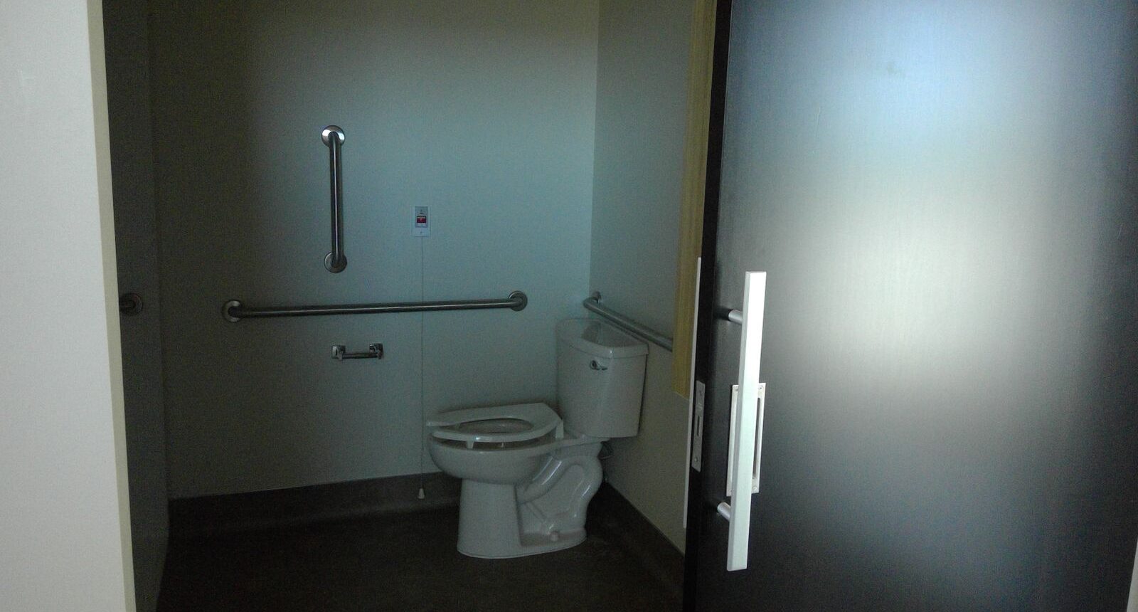 A bathroom with a toilet and a door.