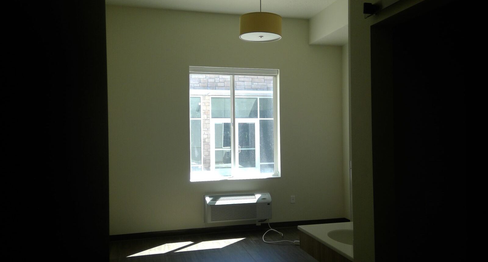 A room with a window and a light in it