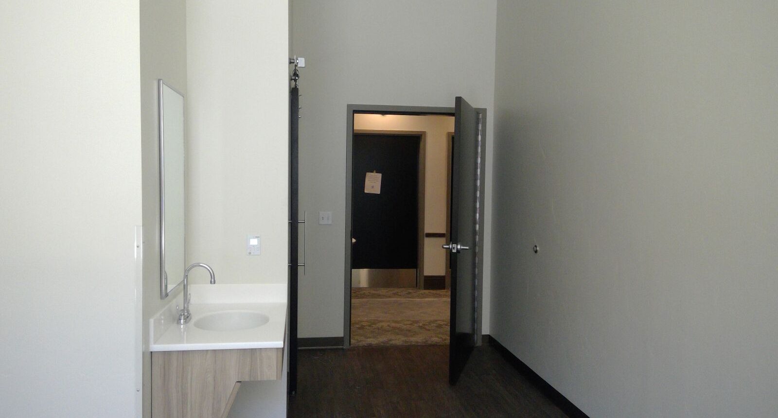 A bathroom with a sink and mirror in it