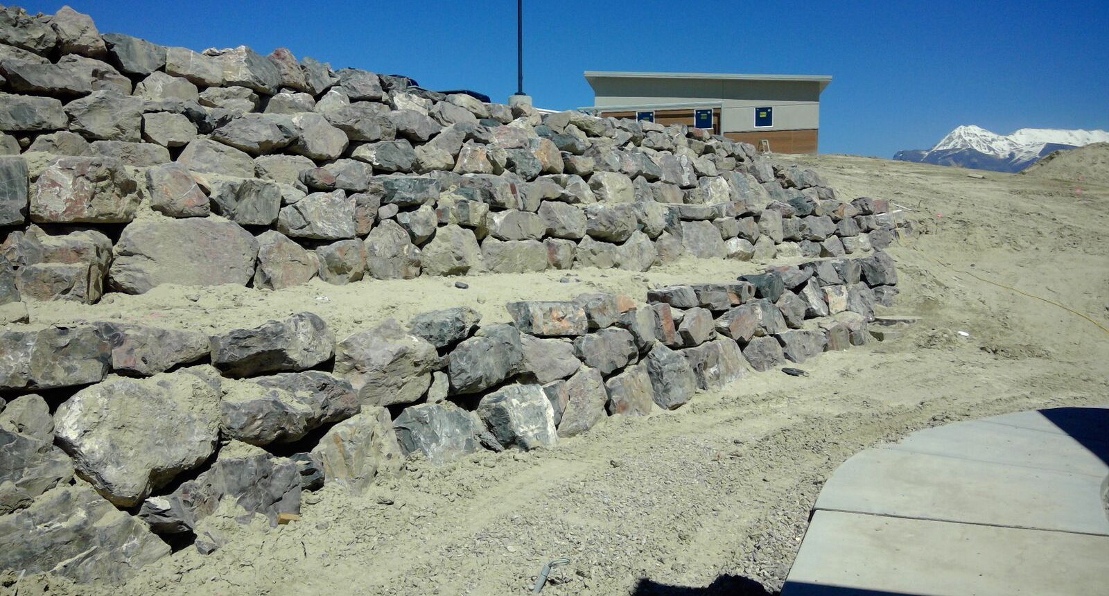 A stone wall with rocks on top of it.