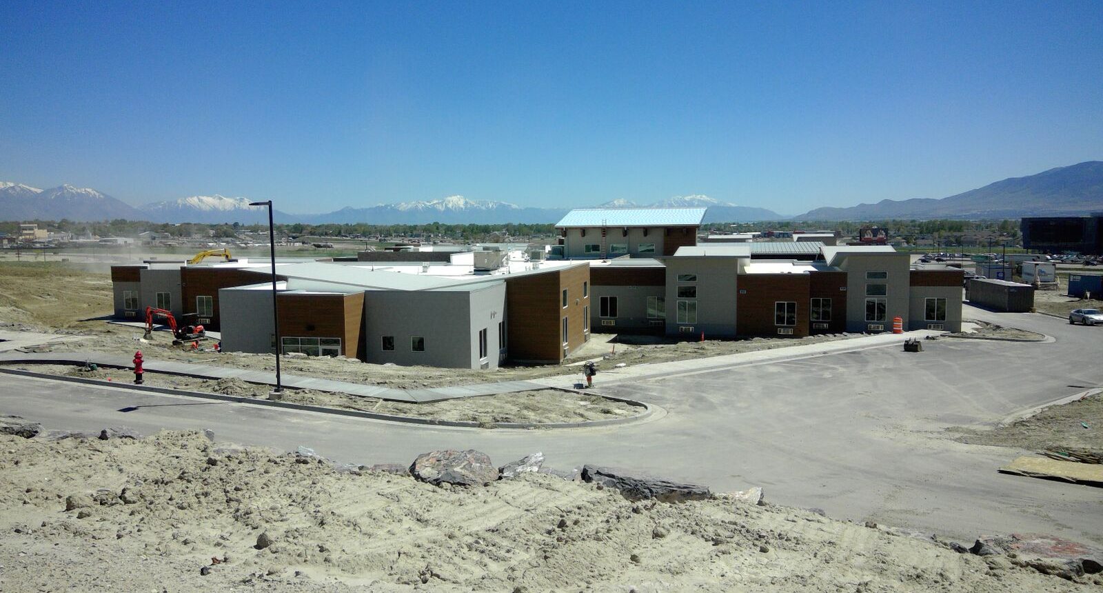 A view of a building from the top of a hill.