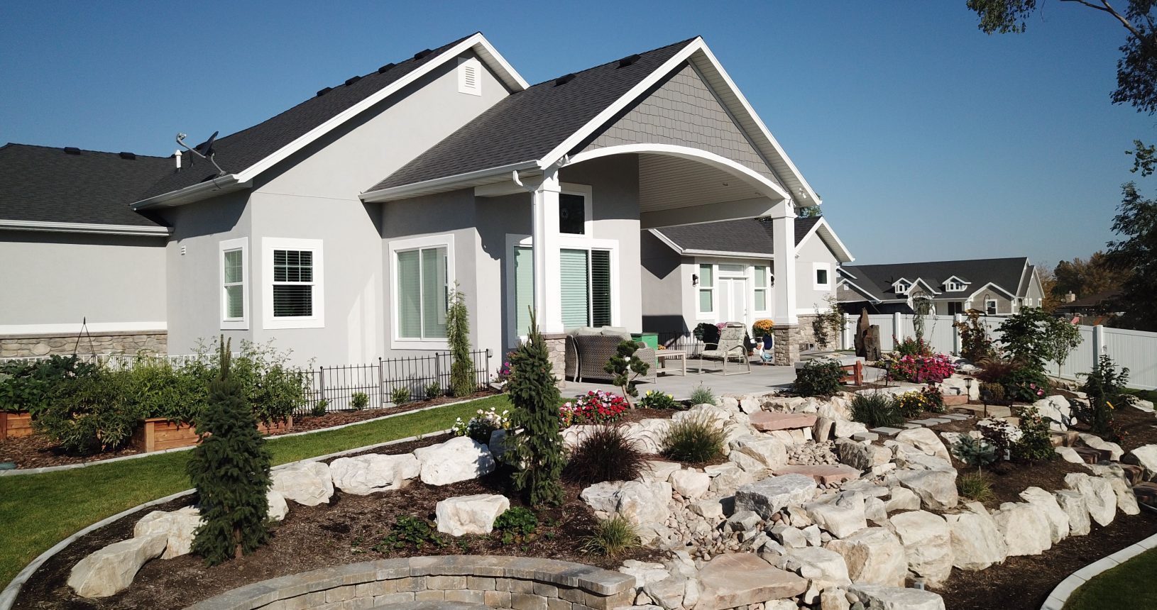 A house with a garden and rocks in the yard