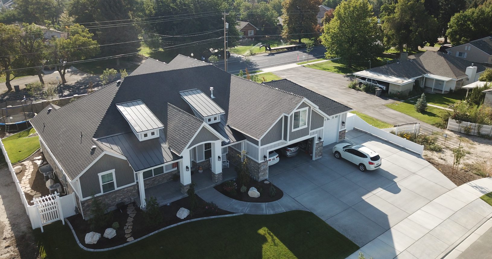 A large house with a driveway and parking lot.