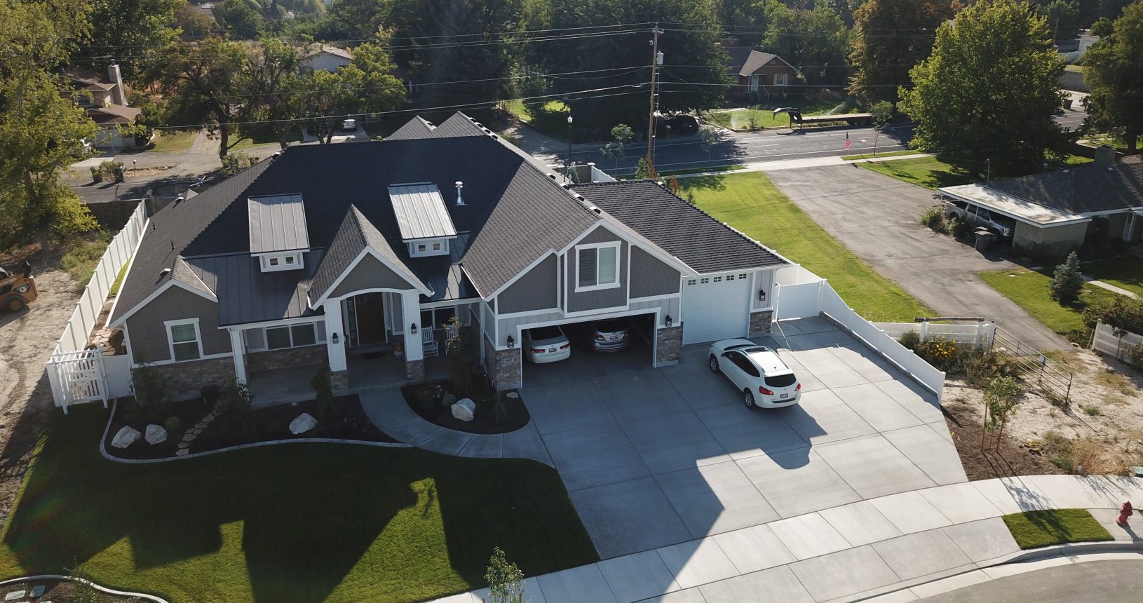 A large house with a driveway and parking lot.