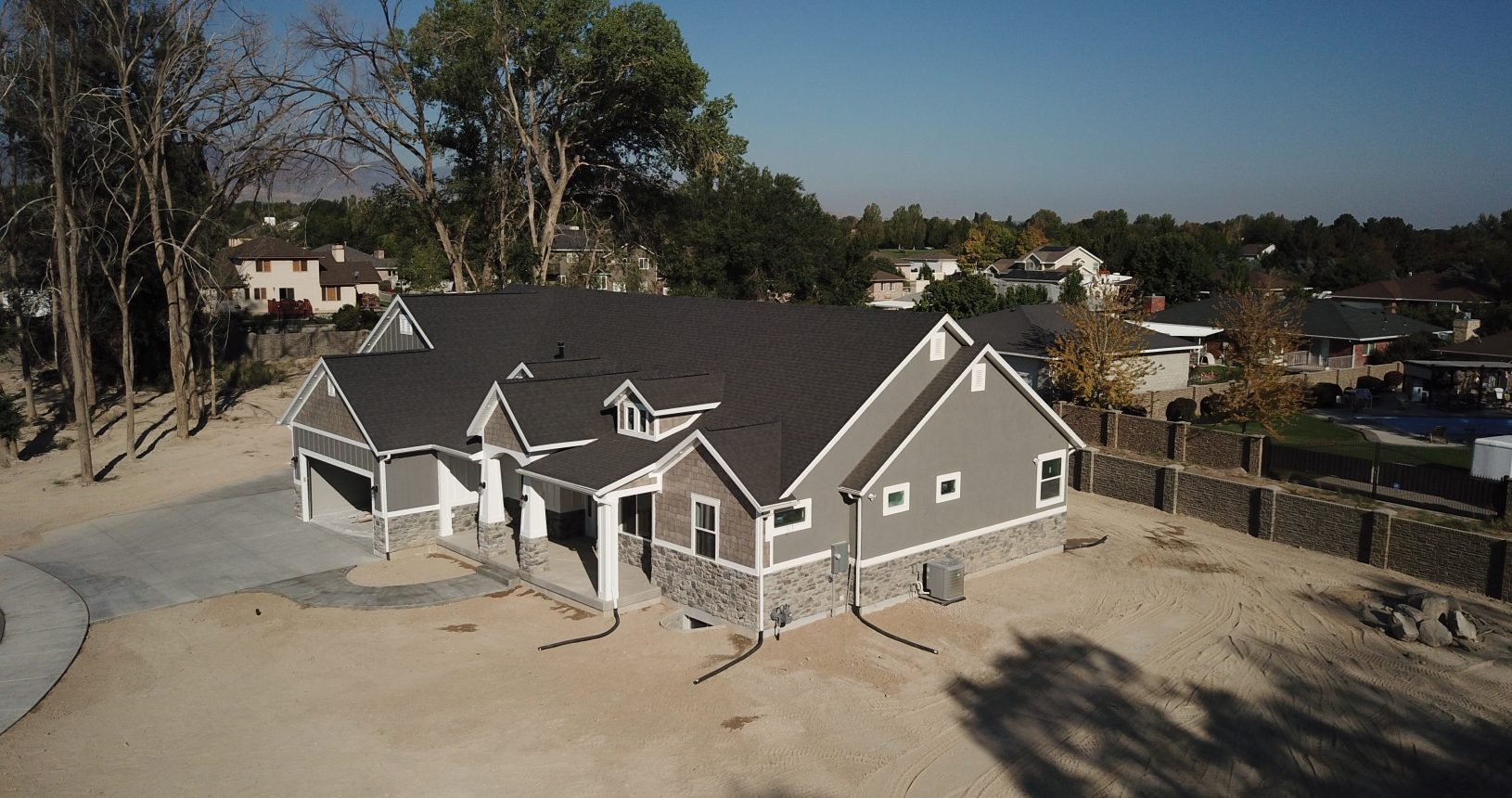 A house with a lot of windows and a roof that is brown.